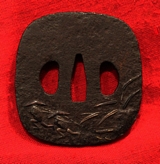 An Iron Plate Katana Edo Tsuba Decorated With Small Figures In Rain Garb