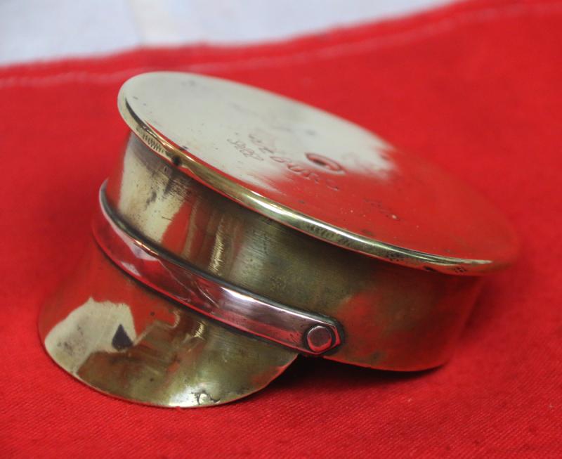 A Delightful Piece of Large Quality 'Trench Art'. A German Shell Trench Engineered Into The Form Of A British 1905 Pattern Trench Service Cap. Wonderful Quality