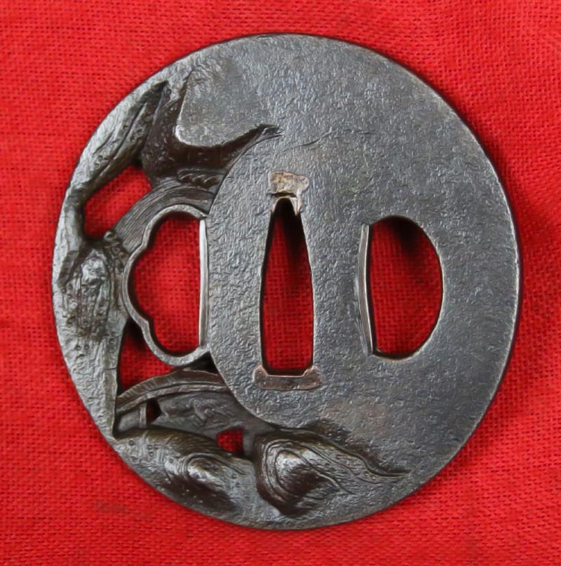 A Fine & Beautiful Edo Period Iron Tsuba in Nikubori Jisukashi Of Waterfalls Rocks and River with A wooden Bridge Being Traversed by a Figure On Horseback Carrying a Parasol