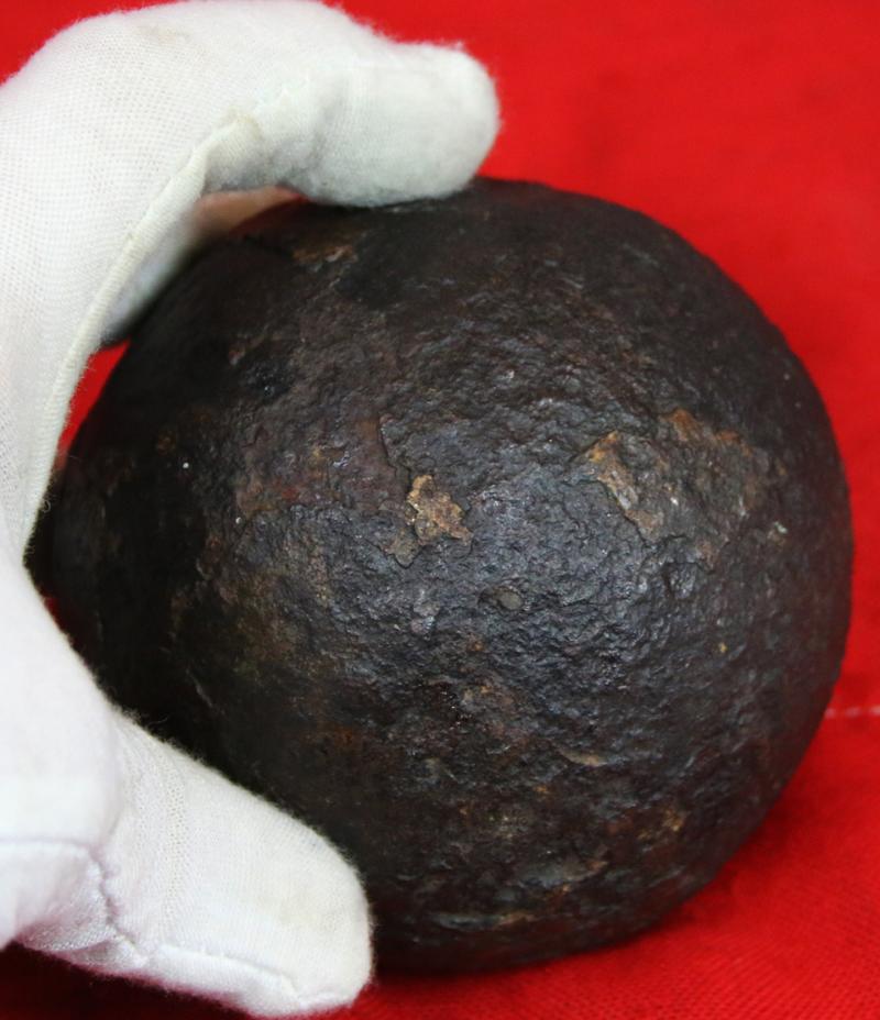 A Superb Original Waterloo Recovered Souvenir '6 Pounder ' Royal Artillery Cannon Ball Fired at La Haye Sainte During The Battle, Recovered From The Farm. With Clear Impact Site To The Ball.