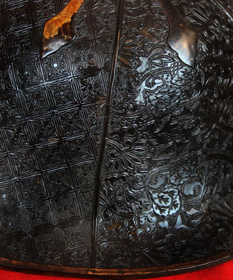 A Beautiful Edo Period Bato Jingasa Samurai Horserider's War Hat With Beautiful Four Flower Panels and Two Geometric Takebori Relief Decor In Six Distinct Panels Within the Urushi Lacquer With Clan Mon
